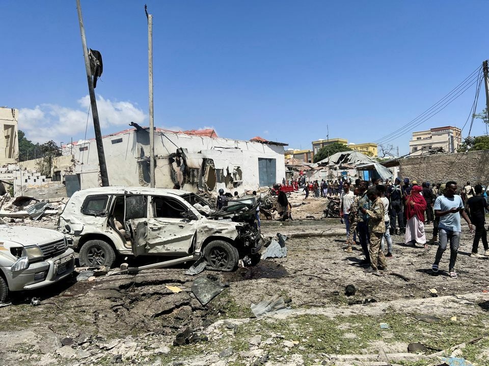 Civilians look at the wrecked vehicles at the scene of an explosion in the Hamarweyne district of Mogadishu, Somalia, January 12, 2022. Reuters Photo