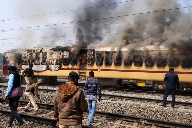 Angry mobs set a train's carriage on fire in protests over access to railway jobs in Gaya, the northeast Indian state of Bihar on Jan 26, 2022. AFP Photo