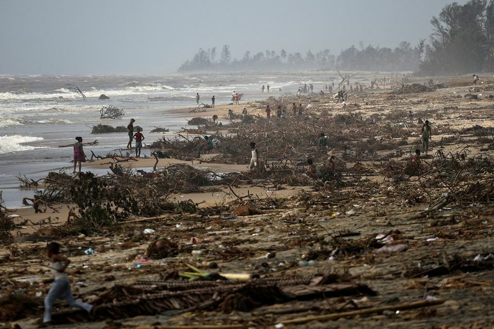 People search debris on the beach, in the aftermath of Cyclone Batsirai, in the town of Mananjary, Madagascar. Reuters
