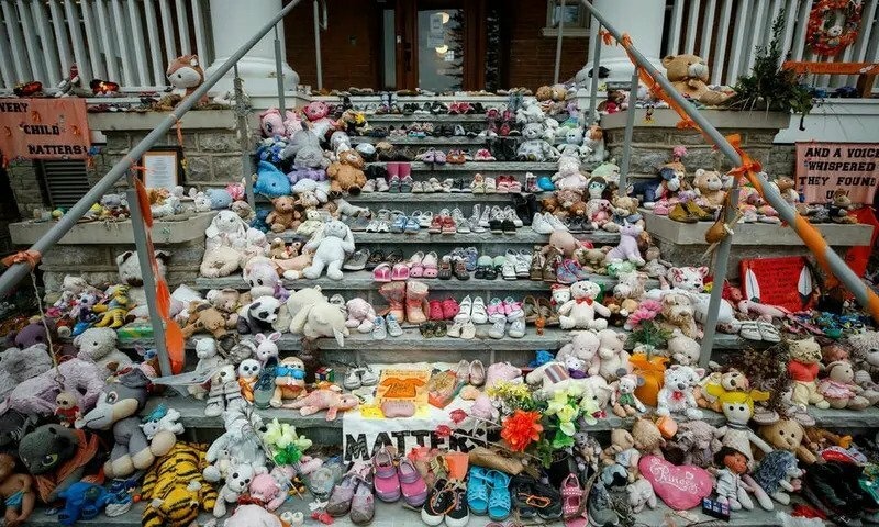 Children shoes and stuffed animals sit on the steps as a tribute to the missing children of the former Mohawk Institute Residential School, in Brantford, Canada in November 2021. The Kapawe'no First Nation in northern Alberta, conducting a similar search for unmarked student graves, says it has uncovered 169 "potential" graves. AFP