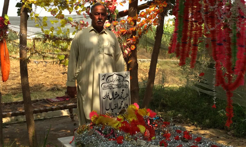 Mashal Khan's father standing with his grave. File photo