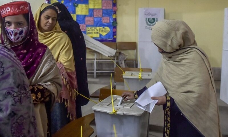 Women stand in a queue inside a polling station during a local body election in Peshawar on December 19, 2020. AFP/File