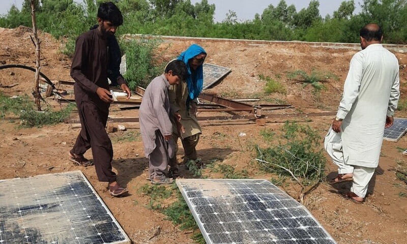 People check the solar plates that got damaged due to heavy rains in Kohlu’s Tehsil Tambu. Aaj News/Muhammad Yousaf