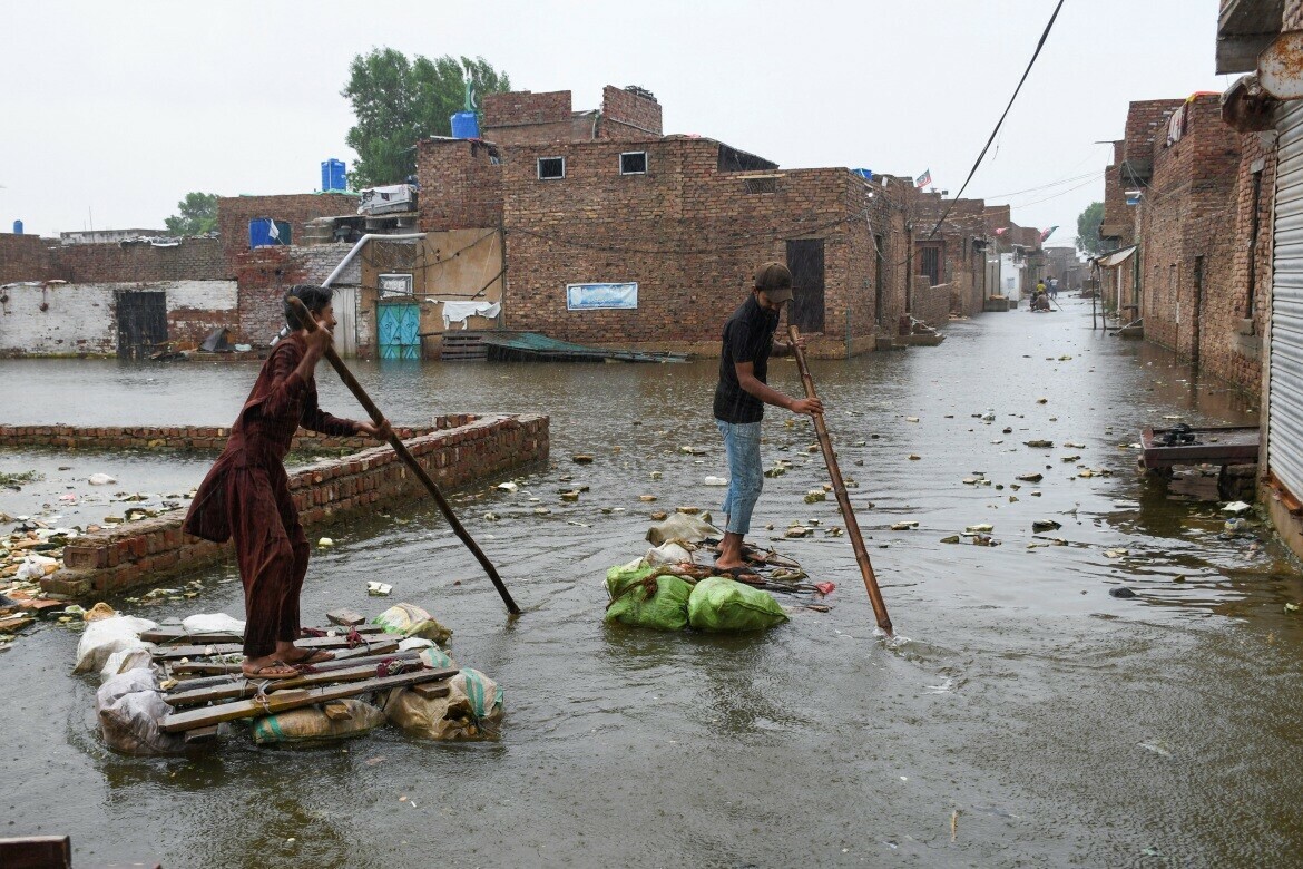 Men paddle on makeshift rafts as they cross a flooded street in Hyderabad, Pakistan. Photo: Reuters/Yasir Rajput/ Men paddle on makeshift rafts as they cross a flooded street in Hyderabad, Pakistan. Photo: Reuters/Yasir Rajput/