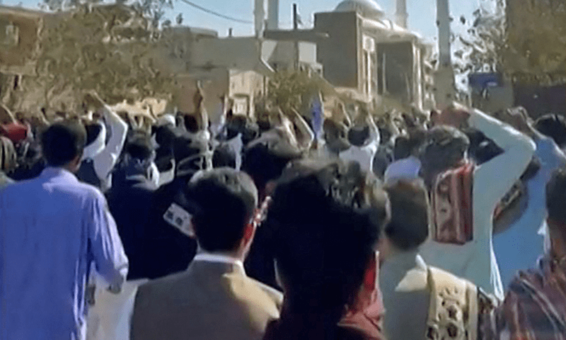 This image grab from a UGC video made available on October 14, 2022, shows Iranian protesters chanting slogans as they march in a street in the southeastern city of Zahedan. Photo via AFP