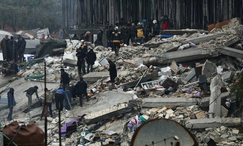 People gather as rescuers search for survivors under the rubble, following an earthquake, in rebel-held town of Jandaris, Syria on February 6, 2023. Reuters