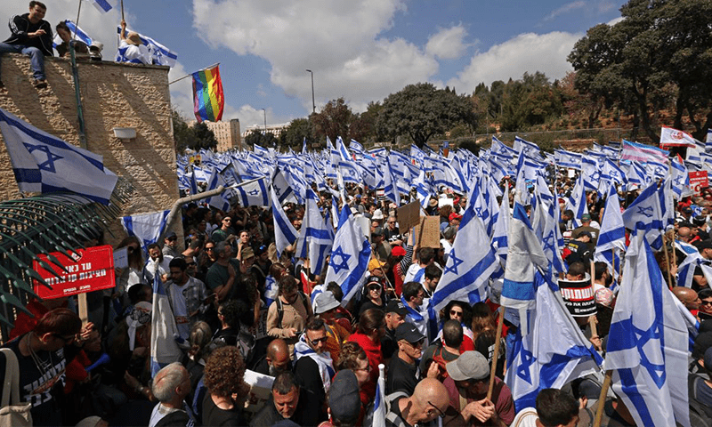 AFP
Protesters gather with national flags outside Israel’s parliament amid ongoing demonstrations in Jerusalem and calls for a general strike against the hard-right government’s controversial push to overhaul the justice system, on March 27, 2023. Photo via AFP. AFP
Protesters gather with national flags outside Israel’s parliament amid ongoing demonstrations in Jerusalem and calls for a general strike against the hard-right government’s controversial push to overhaul the justice system, on March 27, 2023. Photo via AFP.