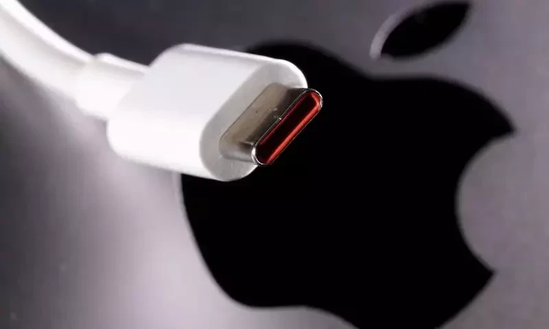 A USB-C (USB Type-C) cable is seen near the Apple logo in this illustration taken October 27, 2022. Reuters