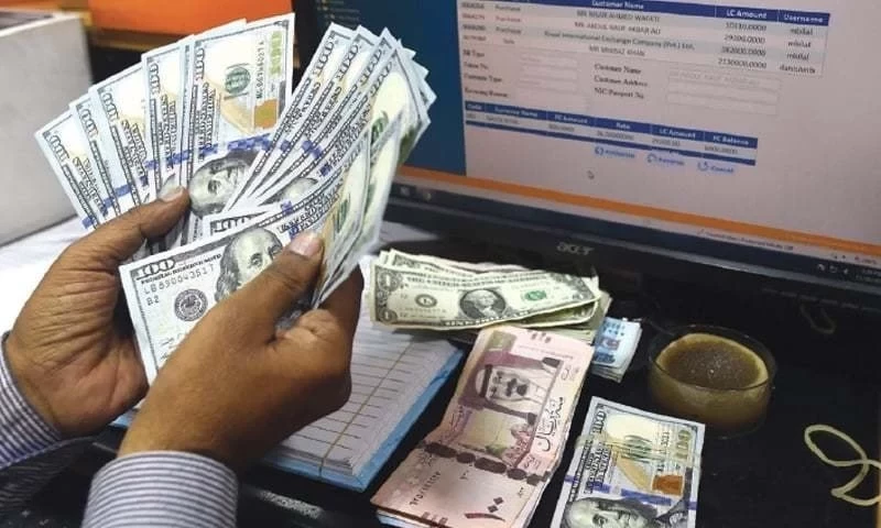 A Pakistani dealer counts US dollars at a currency exchange shop in Karachi on November 30, 2018. AFP/File