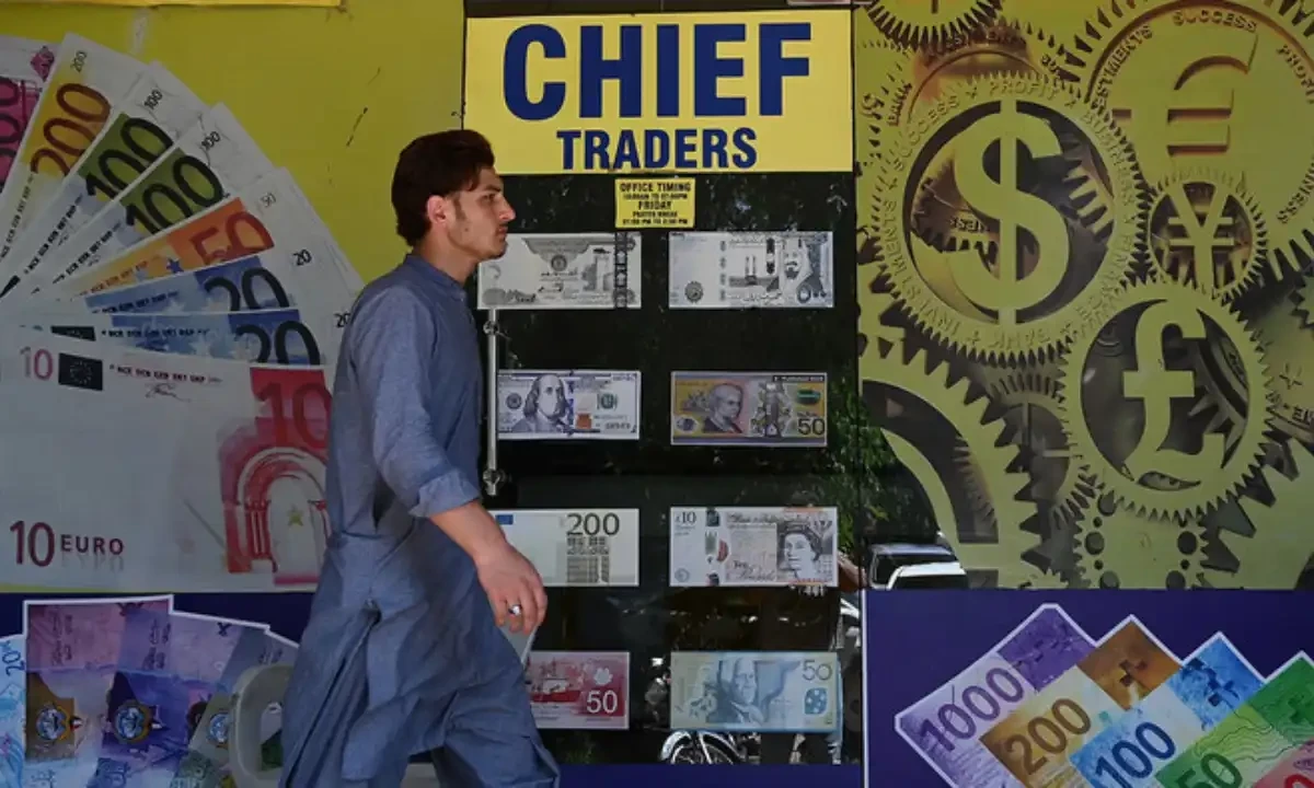A man walks past a foreign currency exchange market in Islamabad, Pakistan on July 11, 2023. AFP/File A man walks past a foreign currency exchange market in Islamabad, Pakistan on July 11, 2023. AFP/File