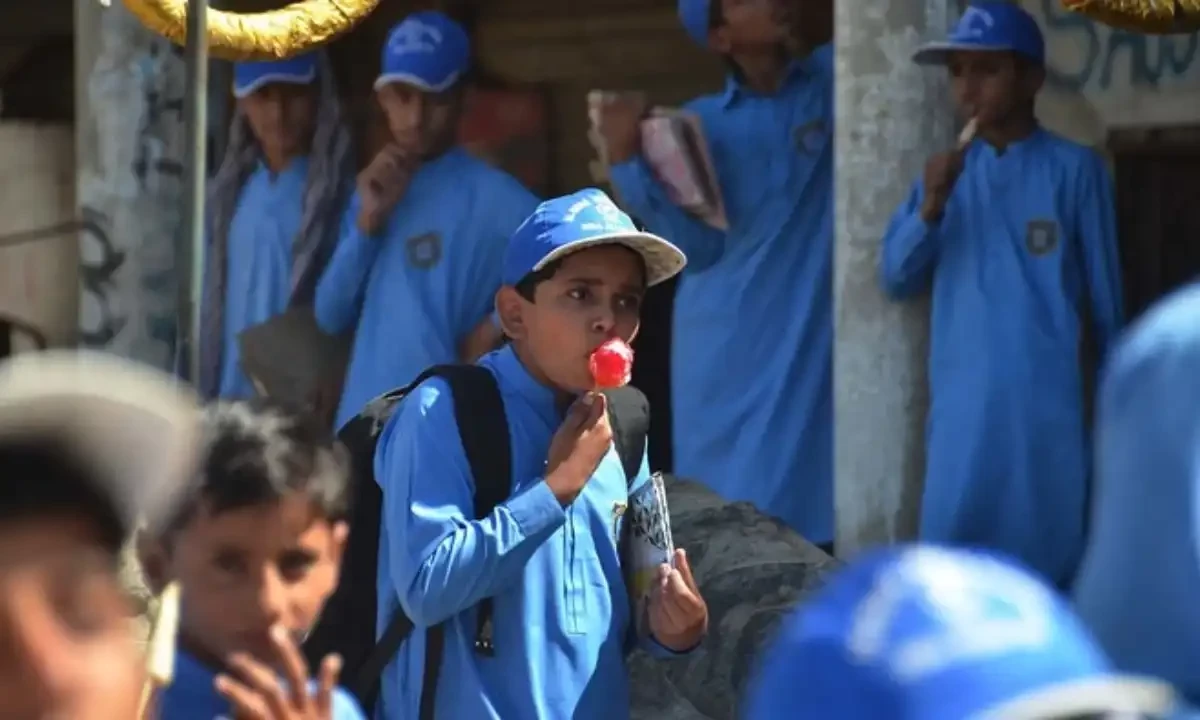 A school boy eats an ice gola (a street dessert made of crushing ice and syrups) outside his school during a hot summer day in Jaffarabad, in Balochistan on May 29, 2024. AFP/File A school boy eats an ice gola (a street dessert made of crushing ice and syrups) outside his school during a hot summer day in Jaffarabad, in Balochistan on May 29, 2024. AFP/File