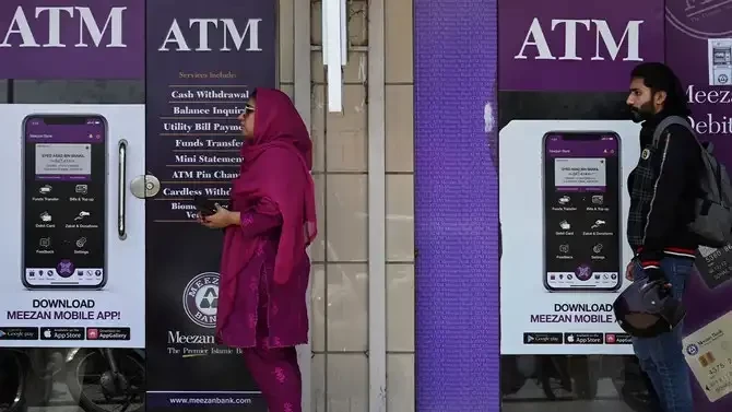 People queue along a street to use an ATM bank machine in Rawalpindi on June 9, 2023. AFP/File People queue along a street to use an ATM bank machine in Rawalpindi on June 9, 2023. AFP/File