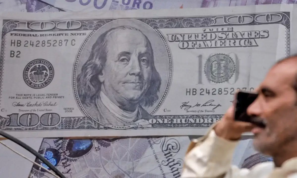 A Pakistani man talks on the phone in front of a poster displaying US dollars at the currency exchange place in Lahore, Pakistan, on May 16, 2019. AFP/File A Pakistani man talks on the phone in front of a poster displaying US dollars at the currency exchange place in Lahore, Pakistan, on May 16, 2019. AFP/File
