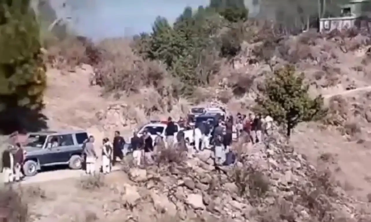 A still from the site of attack shows people gathered around the vehicle part of a convoy that carried Azad Jammu and Kashmir Legislative Assembly Speaker Chaudhry Latif Akbar in Muzaffarabad on January 26, 2025. Screengrab via Aaj News