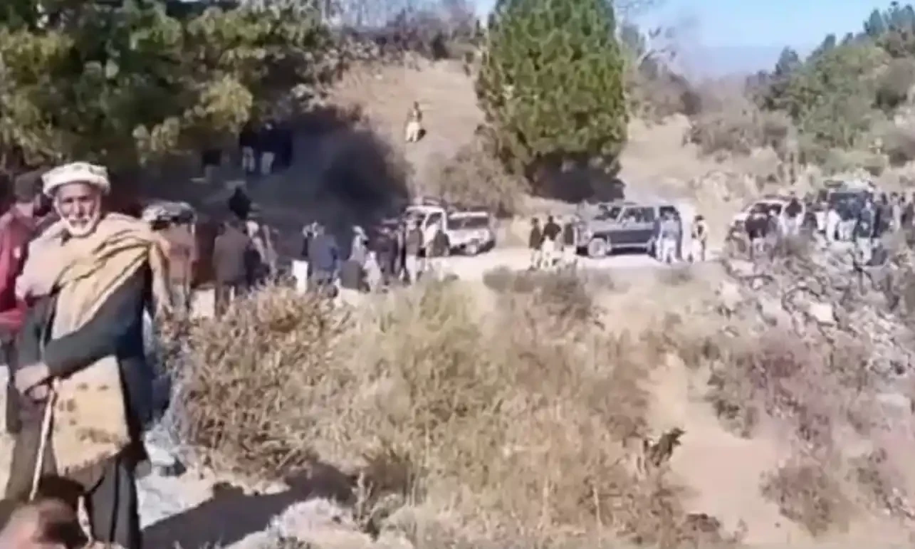 A still from the site of attack shows people gathered around the vehicle part of a convoy that carried Azad Jammu and Kashmir Legislative Assembly Speaker Chaudhry Latif Akbar in Muzaffarabad on January 26, 2025. Screengrab via Aaj News