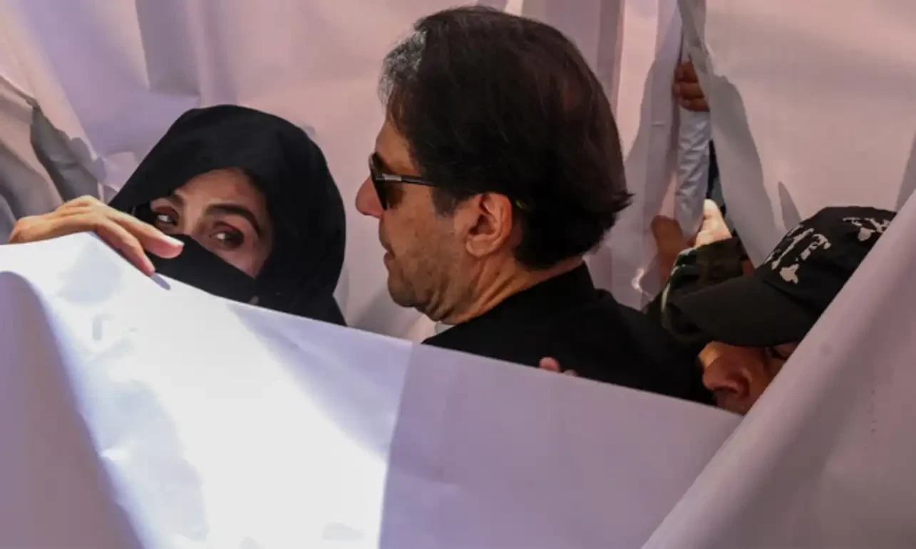 Former prime minister Imran Khan (C) with his wife Bushra Bibi (L) arrive to appear at a high court in Lahore on May 15, 2023. AFP/File Former prime minister Imran Khan (C) with his wife Bushra Bibi (L) arrive to appear at a high court in Lahore on May 15, 2023. AFP/File
