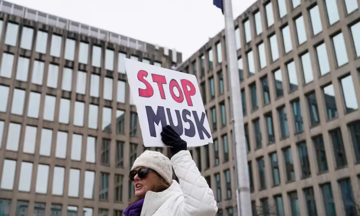People gather to protest outside the headquarters of the Office of Personnel Management (OPM) after the Elon Musk-led DOGE was charged with oversight of OPM, in Washington. Reuters People gather to protest outside the headquarters of the Office of Personnel Management (OPM) after the Elon Musk-led DOGE was charged with oversight of OPM, in Washington. Reuters