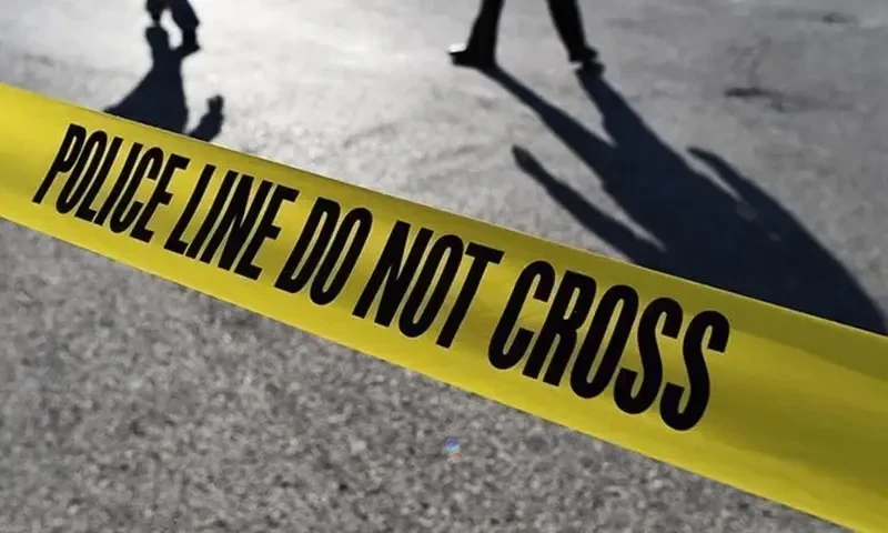 Police officials stand behind crime scene tape. AFP/File Police officials stand behind crime scene tape. AFP/File