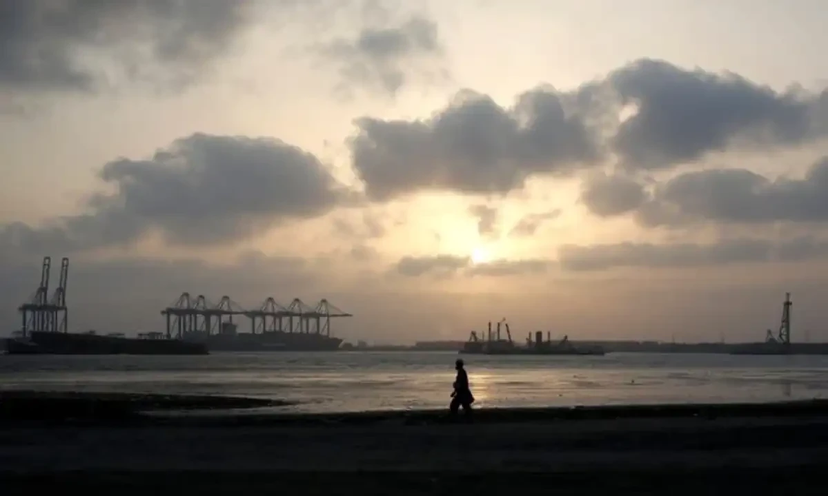 A man is silhouetted as he walks amid hot and humid weather at breakwater along port area in Karachi, Pakistan May 7, 2018. Reuters
