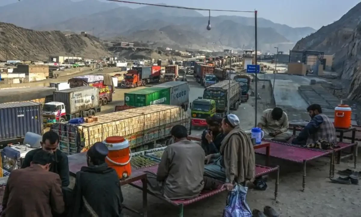 Drivers take rest as stranded trucks are pictured near the Pakistan-Afghanistan border in Torkham on January 16, 2024. AFP