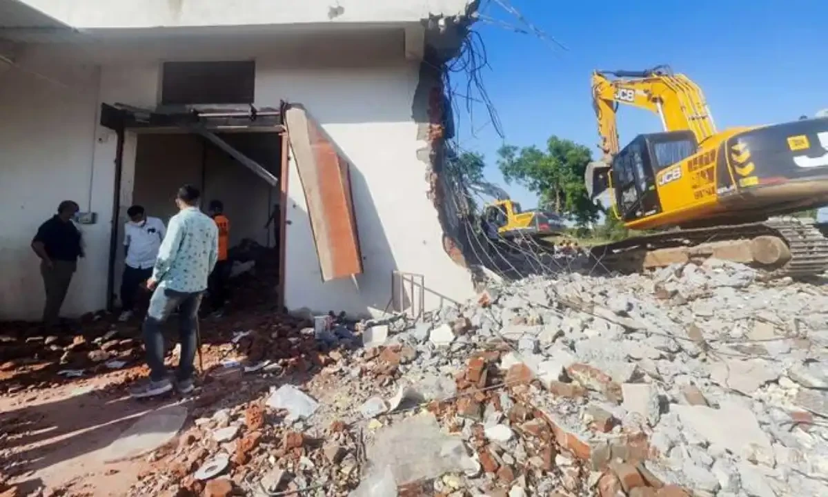 People stand amid debris at a blast site in a firework factory in Deesa, in India’s Gujarat state on Apr. 1, 2025. (AFP)