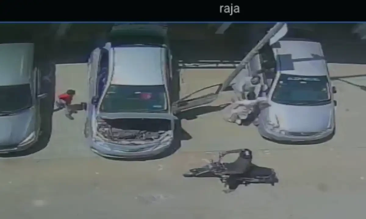 This image grab from CCTV footage shows robbers (right) engage Amir as his young son in red shirt (left) sees the robbery unfold.