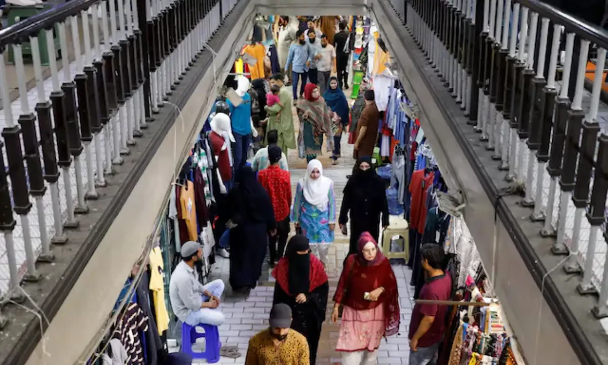 People walk as they shop in a market, ahead of Eid al-Fitr celebrations in Karachi, Pakistan April 19, 2023. Reuters People walk as they shop in a market, ahead of Eid al-Fitr celebrations in Karachi, Pakistan April 19, 2023. Reuters