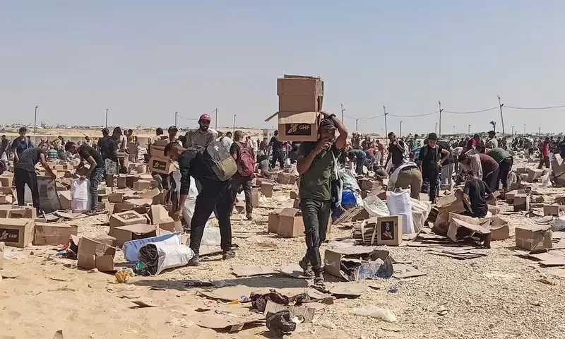 Palestinians gather to collect what remains of relief supplies from the distribution center of the U.S.-backed Gaza Humanitarian Foundation, in Rafah, in the southern Gaza Strip, June 5, 2025. Reuters