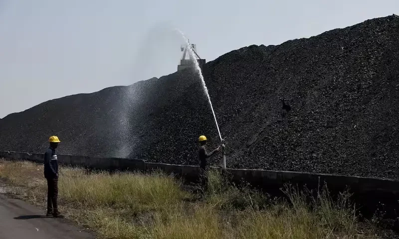 Employee’s perform cooling operations where coal is stored at the NTPC (National Thermal Power Corporation) power plant in Solapur, India, March 2, 2025. Reuters