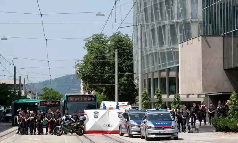 Police officers stand as children are evacuated from the school, following a deadly school shooting in Graz, Austria, June 10, 2025. REUTERS Police officers stand as children are evacuated from the school, following a deadly school shooting in Graz, Austria, June 10, 2025. REUTERS