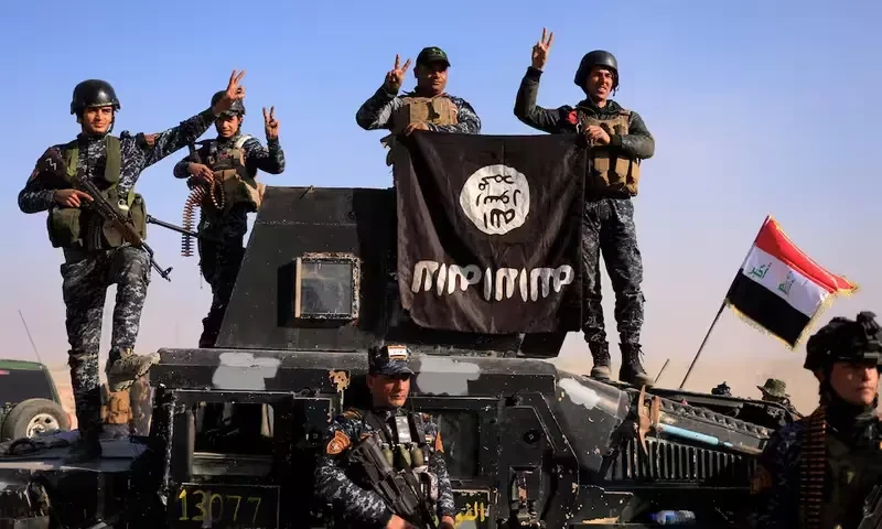 Federal police members pose with an Islamic State (IS) flag along a street of Albu Saif which was recaptured from Islamic State, south of Mosul, Iraq, February 22, 2017. Reuters Federal police members pose with an Islamic State (IS) flag along a street of Albu Saif which was recaptured from Islamic State, south of Mosul, Iraq, February 22, 2017. Reuters