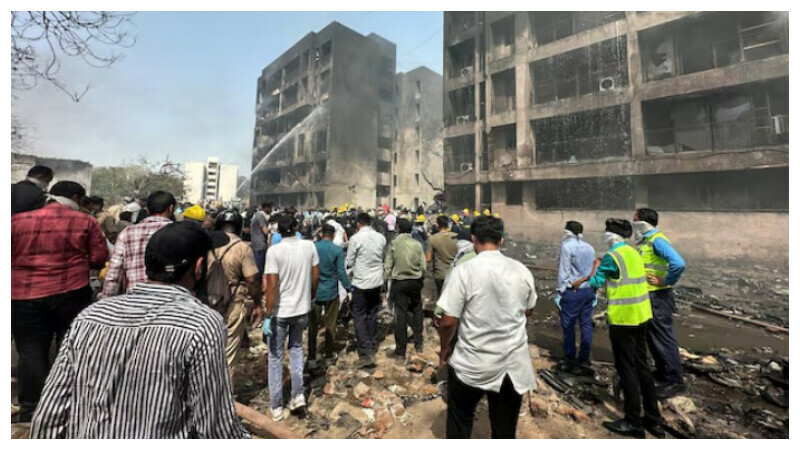 People gather near the site where an Air India plane crashed in Ahmedabad, India, June 12, 2025. REUTERS People gather near the site where an Air India plane crashed in Ahmedabad, India, June 12, 2025. REUTERS