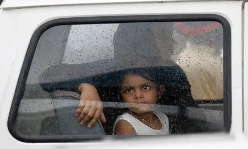 A girl looks out of a car window with raindrops during the season’s first monsoon rain in Karachi on July 6, 2020. Reuters
