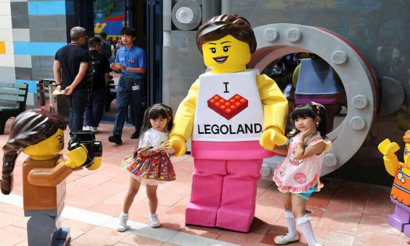 Children pose for a photo with a mascot as they visit Legoland Shanghai Resort during a media tour in Shanghai. – Reuters Children pose for a photo with a mascot as they visit Legoland Shanghai Resort during a media tour in Shanghai. – Reuters