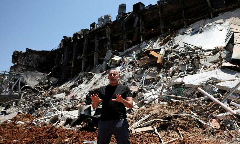 Professor Roee Ozeri speaks to the media surrounded by rubble at the campus of the Weizmann Institute following an Iranian missile strike in Rehovot, Israel. – Reuters