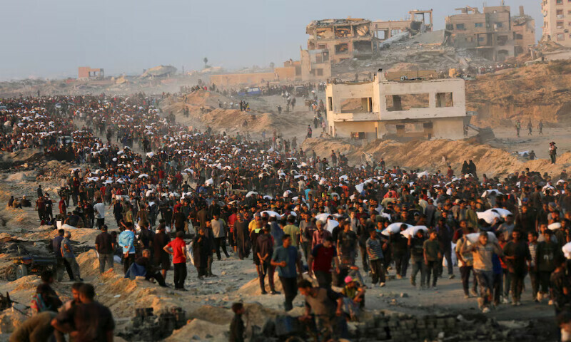 Palestinians gather to receive aid supplies in Beit Lahia, in the northern Gaza Strip. – Reuters file Palestinians gather to receive aid supplies in Beit Lahia, in the northern Gaza Strip. – Reuters file