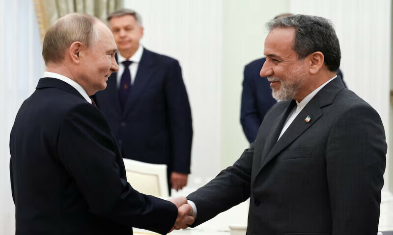 Russian President Vladimir Putin shakes hands with Iranian Foreign Minister Abbas Araghchi during a meeting at the Kremlin in Moscow on Monday. – Reuters
