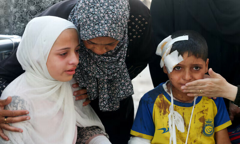 An injured boy and other mourners react during the funeral of Palestinians who were killed by Israeli fire while trying to receive aid in central Gaza Strip on Tuesday. – Reuters An injured boy and other mourners react during the funeral of Palestinians who were killed by Israeli fire while trying to receive aid in central Gaza Strip on Tuesday. – Reuters