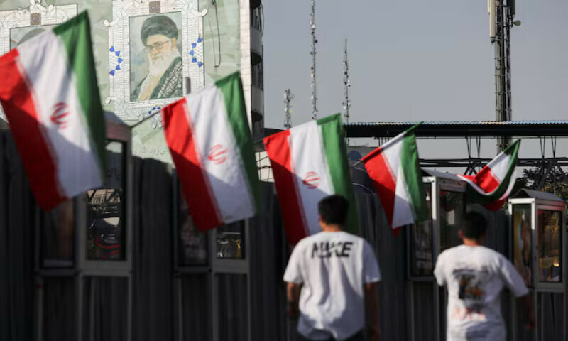 People walk near a mural of Iran’s Supreme Leader, Ayatollah Ali Khamenei, in Tehran. – Reuters People walk near a mural of Iran’s Supreme Leader, Ayatollah Ali Khamenei, in Tehran. – Reuters