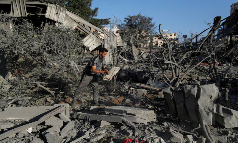 A Palestinian inspects the site of an Israeli air strike on a house in Gaza City on Thursday. – Reuters A Palestinian inspects the site of an Israeli air strike on a house in Gaza City on Thursday. – Reuters