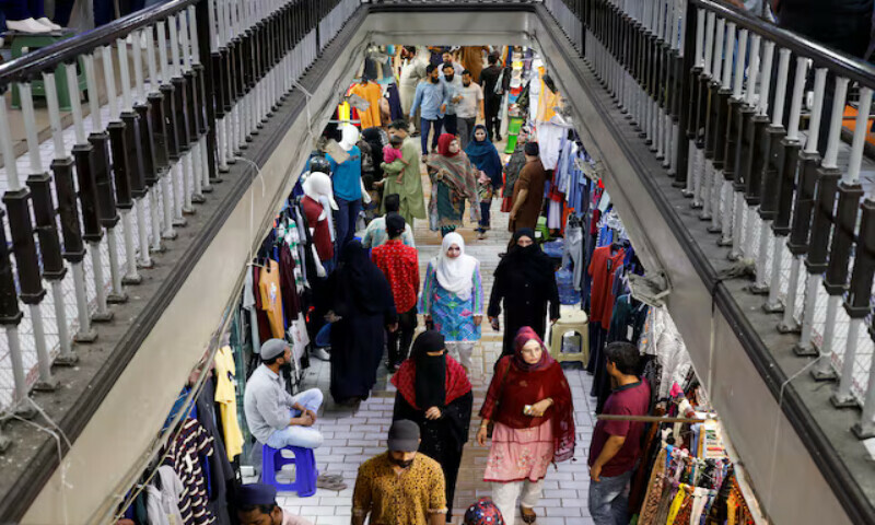 People walk as they shop in a market in Karachi, Pakistan. – Reuters file People walk as they shop in a market in Karachi, Pakistan. – Reuters file