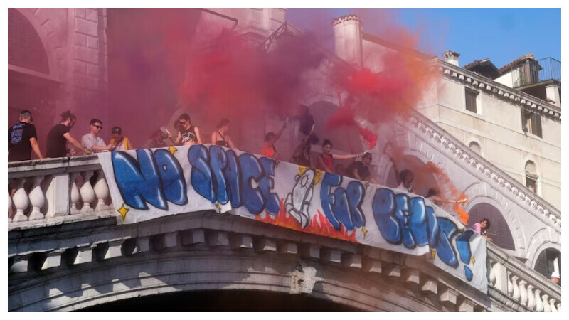Demonstrators on the Rialto Bridge, hold smoke flares while standing by a banner that reads ‘No space for Bezos’ as they take part in a protest against Amazon founder Jeff Bezos, on the third day of Jeff Bezos and his wife Lauren Sanchez Bezos’ wedding festivities, in Venice, Italy, June 28, 2025. REUTERS Demonstrators on the Rialto Bridge, hold smoke flares while standing by a banner that reads ‘No space for Bezos’ as they take part in a protest against Amazon founder Jeff Bezos, on the third day of Jeff Bezos and his wife Lauren Sanchez Bezos’ wedding festivities, in Venice, Italy, June 28, 2025. REUTERS