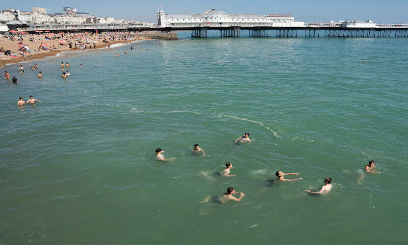 Beachgoers swim in the sea during warm weather in Brighton, Britain, on Monday. – Reuters Beachgoers swim in the sea during warm weather in Brighton, Britain, on Monday. – Reuters