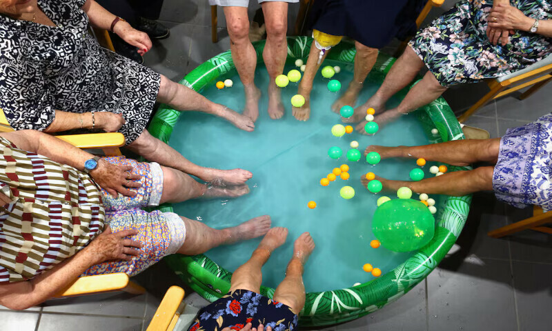 Residents dip their feet in a pool to cool down in Grimbergen, Belgium, on Monday. –Reuters Residents dip their feet in a pool to cool down in Grimbergen, Belgium, on Monday. –Reuters