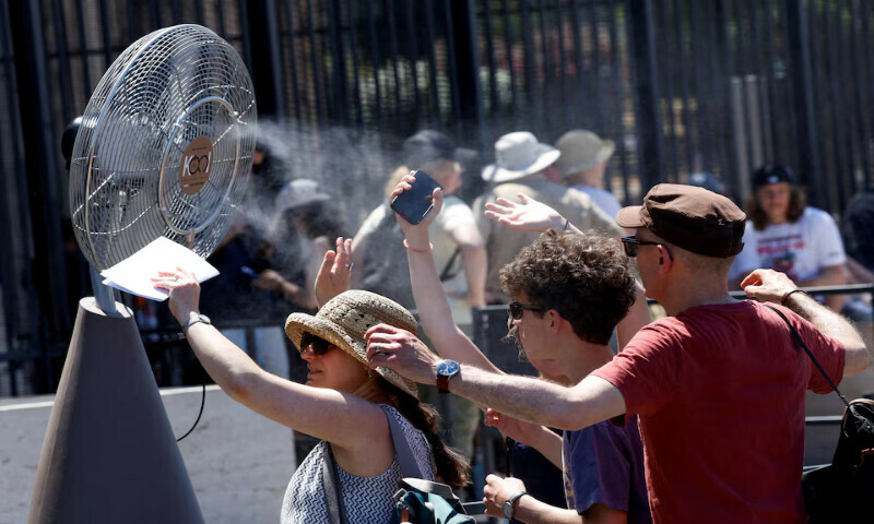 Tourists stand in front of a cooling fan installed outside the Colosseum in during the heatwave in Rome, Italy, on Monday. – Reuters Tourists stand in front of a cooling fan installed outside the Colosseum in during the heatwave in Rome, Italy, on Monday. – Reuters