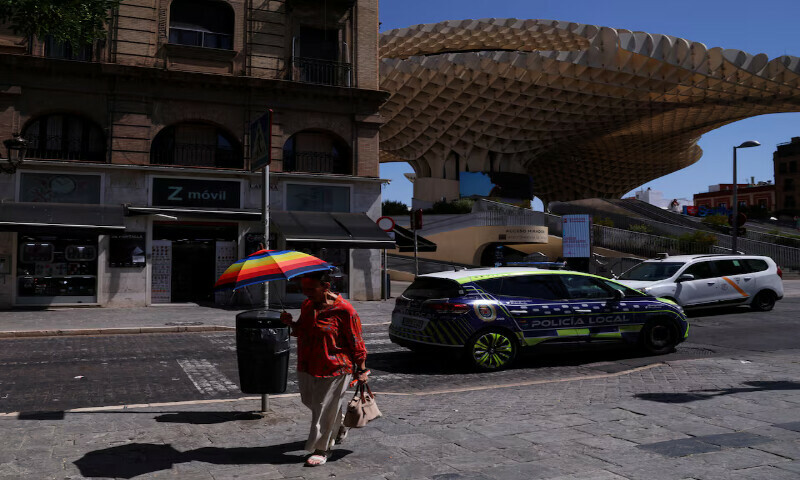 A woman carries an umbrella nearby Las Setas during a heatwave in Seville, Spain, on Wednesday. – Reuters A woman carries an umbrella nearby Las Setas during a heatwave in Seville, Spain, on Wednesday. – Reuters