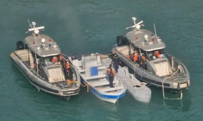 An unmanned semi-submersible, known as a Low Profile Vessel, between two Colombian Navy vessels, July 2, 2025. — AFP An unmanned semi-submersible, known as a Low Profile Vessel, between two Colombian Navy vessels, July 2, 2025. — AFP