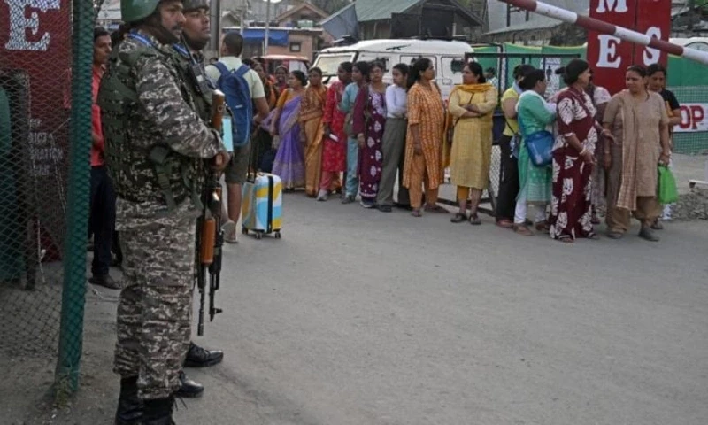 Indian security personnel stand guard as Hindu pilgrims await their registration ahead of the the annual Amarnath pilgrimage. — AFP Indian security personnel stand guard as Hindu pilgrims await their registration ahead of the the annual Amarnath pilgrimage. — AFP