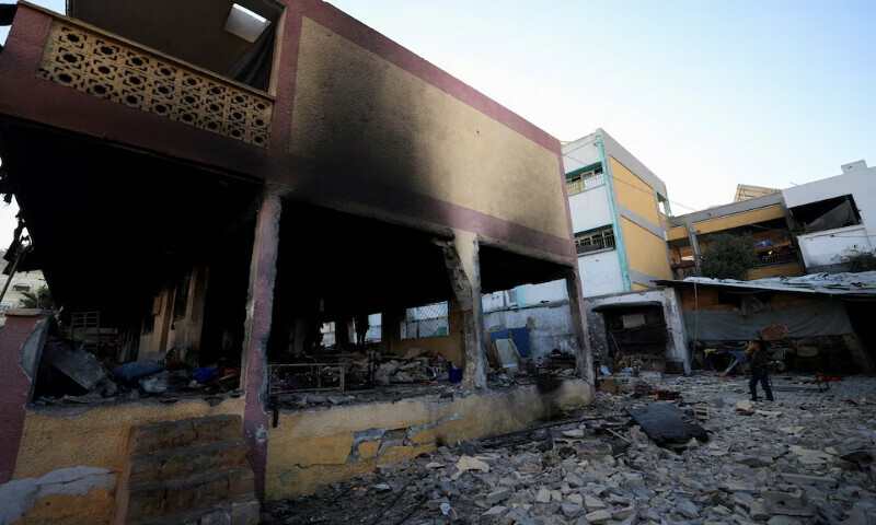 A Palestinian girl looks at the damage at a school sheltering displaced people following an Israeli airstrike in Gaza City on Thursday. – Reuters A Palestinian girl looks at the damage at a school sheltering displaced people following an Israeli airstrike in Gaza City on Thursday. – Reuters