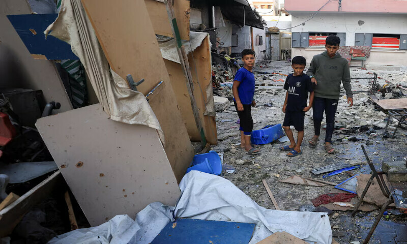 Palestinians inspect the damage at a school sheltering displaced people following an Israeli airstrike in Gaza City on Thursday. – Reuters Palestinians inspect the damage at a school sheltering displaced people following an Israeli airstrike in Gaza City on Thursday. – Reuters
